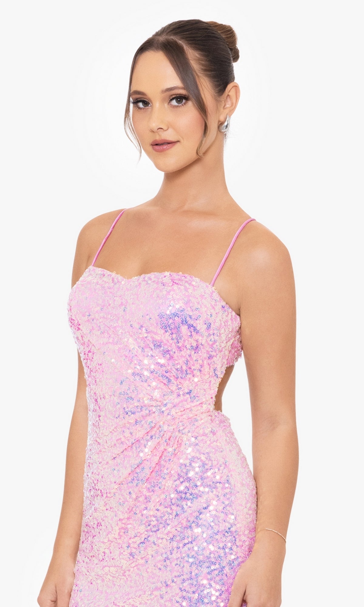 A woman poses against a white background wearing the Short Party Dress BC116 by Blondie Nites, featuring sparkly light pink sequins and thin straps.